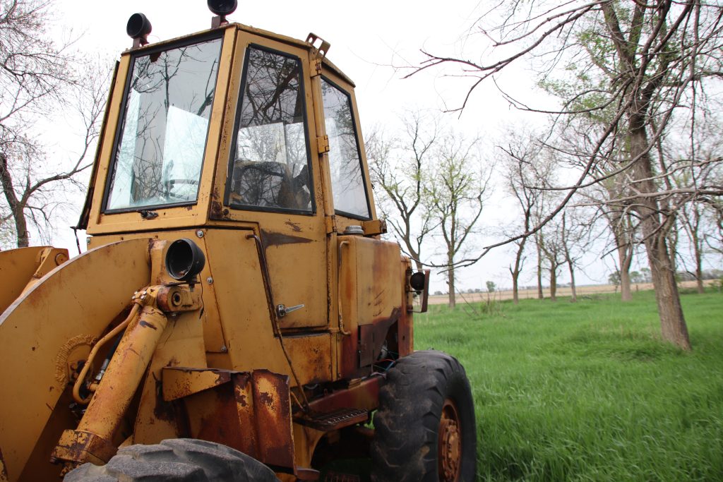 loader parked in a grassy field