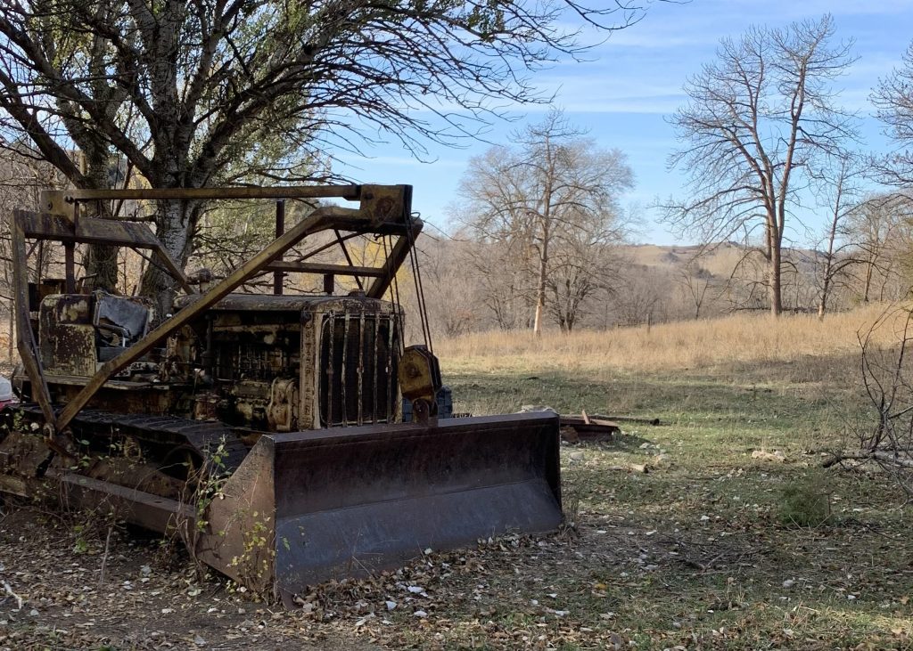 1920s bulldozer parked in a field